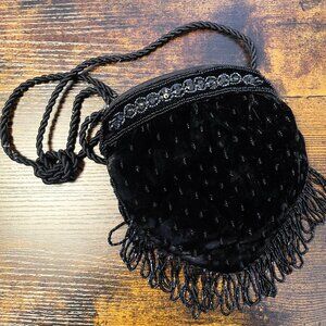 Black velvet beaded evening bag with fringe and a twisted rope strap